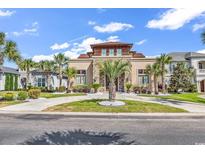 Stunning home featuring stone accents, manicured landscaping, circular driveway, and a well-maintained lawn at 194 Avenue Of The Palms, Myrtle Beach, SC 29579