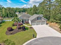 Beautiful single Gathering home with three-car garage, mature landscaping, and brick accents at 229 Duchess Ct., Myrtle Beach, SC 29588