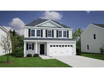 Charming two-story home with a two-car garage and well-maintained landscaping at 261 Mayflower Dr., Calabash, NC 28467