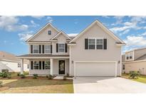Charming two-story home featuring light gray siding, black shutters, and an attached two-car garage at 341 Glacier Way, Conway, SC 29526