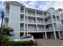 Multi-level condo building featuring pastel exterior and stacked balconies at 407 24Th Ave. N # 302, North Myrtle Beach, SC 29582