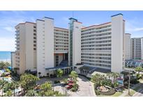 Oceanfront resort showcasing a modern facade, inviting entrance, and lush landscaping for a welcoming experience at 5300 N Ocean Blvd. # 518, Myrtle Beach, SC 29577