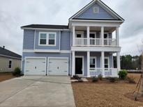 Charming two-story home features a double garage and a welcoming porch at 532 Magnolia Terrace Dr, Myrtle Beach, SC 29579