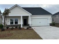 Charming single-Gathering home featuring a two-car garage, landscaped yard, and inviting front porch at 534 Magnolia Terrace Dr, Myrtle Beach, SC 29579