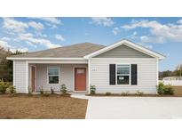 Charming single-story home featuring a tidy lawn and a welcoming coral front door at 627 Culmen Ct., Myrtle Beach, SC 29588