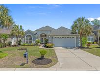 Charming single story home boasts a well manicured lawn, paved driveway and large garage at 631 Edgecreek Dr., Myrtle Beach, SC 29579