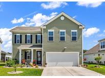 Charming two-story home with a well-manicured lawn and a welcoming front porch at 732 Mustang Ranch Dr., Myrtle Beach, SC 29588