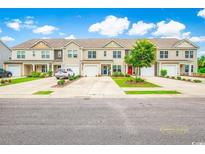 Charming townhomes with individual garages, driveways, and manicured landscaping enhance curb appeal at 1147 Fairway Ln. # 1147, Conway, SC 29526