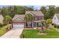 Charming two-story brick home with well-maintained landscaping and a welcoming front porch at 1416 Castleberry Pl., Myrtle Beach, SC 29588