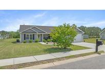 Charming single-story home with well-manicured lawn, rock garden, and attached two-car garage at 1536 Abberbury Dr., Conway, SC 29527