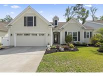 Charming home featuring a well-manicured front yard and an attached two-car garage at 1681 Suncrest Dr., Myrtle Beach, SC 29577