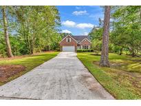 Charming single-Gathering home with brick facade, attached garage, and long private driveway at 1729 Longleaf Dr., Myrtle Beach, SC 29575