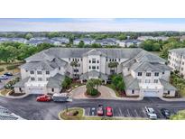 Stunning exterior view of a condo building with manicured landscaping and ample parking at 2180 Waterview Dr. # 1044, North Myrtle Beach, SC 29582