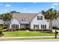 Charming single-Gathering home featuring manicured lawn and mature palm trees at 235 Welcome Dr., Myrtle Beach, SC 29579