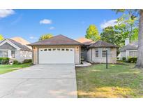 Charming single story home with a two-car garage and well maintained lawn in a desirable community at 3107 Robyn Ct., Little River, SC 29566