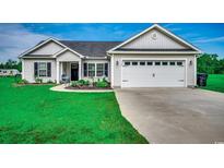 Charming one-story home features a two-car garage, landscaped front yard, and inviting entryway at 3148 Gause Rd., Loris, SC 29569