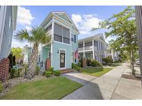 Charming two-story home with a lovely screened porch and manicured front yard landscaping at 3381 Pampas Dr., Myrtle Beach, SC 29577