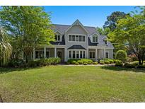 Beautiful two-story home with manicured lawn and mature landscaping at 352 Old Carriage Loop, Georgetown, SC 29440