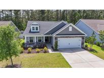 Charming single-Gathering home showcasing stone accents and a well-manicured lawn at 3725 Park Pointe Ave., Little River, SC 29566
