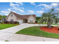 Beautiful single-story brick home with a well manicured lawn, long driveway, and palm tree at 3757 Kingsley Dr., Myrtle Beach, SC 29588
