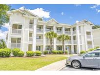 Charming condo with stacked balconies, lush landscaping, and a well-maintained exterior at 453 Red River Ct. # 38 I, Myrtle Beach, SC 29579