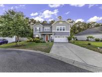 Charming two-story home with a well-manicured lawn and a driveway leading to a two-car garage at 6239 Chadderton Circle, Myrtle Beach, SC 29579
