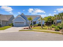 Charming, single-story home with manicured lawn, mature landscaping, and a two-car garage at 6591 Cagliari Court, Myrtle Beach, SC 29572