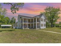 Charming two-story home featuring double porches, black shutters and a lovely lawn at 675 Liberty Church Rd., Loris, SC 29569