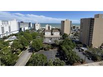An aerial view of a coastal condo complex and nearby resorts with an ocean view in Myrtle Beach, South Carolina at 7509 N Ocean Blvd. # 1205, Myrtle Beach, SC 29572