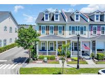 Charming townhome with a covered front porch and colorful shutters in a well-maintained community at 830 Shine Ave. # 28 R8, Myrtle Beach, SC 29577