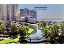 Beautiful aerial view of a condo building complex overlooking a bridge and a pristine beach at 9840 Queensway Blvd. # 1505, Myrtle Beach, SC 29572