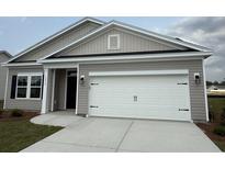 Charming single-story home featuring a two-car garage and a well-maintained front yard at 1029 Jase Dr., Longs, SC 29568