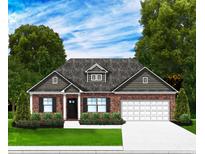 Charming single-story brick home featuring a manicured lawn and attached two-car garage at 1033 Jase Dr., Longs, SC 29568