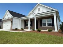 Inviting brick and vinyl sided home featuring a charming front porch with white columns and well-manicured lawn at 1033 Jase Dr., Longs, SC 29568