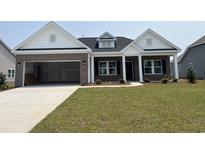 Charming brick home featuring an attached garage and a well-manicured front lawn at 1033 Jase Dr., Longs, SC 29568