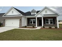 Charming brick home featuring a two-car garage, manicured lawn, and inviting front porch at 1033 Jase Dr., Longs, SC 29568