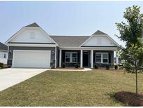 Charming single-story home with gray siding, white trim, stone accents, and a well-manicured lawn at 1037 Jase Dr., Longs, SC 29568