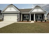 Charming single-story home featuring a two-car garage and a welcoming covered front porch at 1037 Jase Dr., Longs, SC 29568