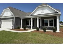 Charming single-story home with gray siding, stone accents, and a well-manicured front yard at 1037 Jase Dr., Longs, SC 29568