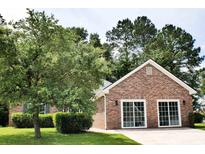 Charming brick home featuring a well-manicured lawn and an attached two-car garage at 104 Jessica Lakes Dr., Conway, SC 29526