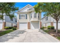 Charming two-story home boasts a two-car garage, well-maintained landscaping and a welcoming facade at 1379 Cottage Dr., Myrtle Beach, SC 29577