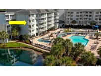 Beautiful pool area with multiple levels, seating, and lush landscaping at this condominium complex at 14290 Ocean Hwy. # 312, Pawleys Island, SC 29585