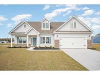 Charming one-story home boasts a two-car garage, manicured lawn, and a welcoming entrance at 178 Six Mile Creek Dr., Georgetown, SC 29440