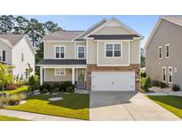 Charming two-story home with a two-car garage, well-maintained lawn, and inviting curb appeal at 1808 Zodiac Court, Myrtle Beach, SC 29577