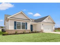 Charming single-Gathering home with white siding, brick accents, blue shutters and a well-maintained lawn at 192 Six Mile Creek Dr., Georgetown, SC 29440