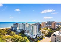 Stunning aerial view of the beachfront condo complex with beautiful ocean views and blue skies at 215 77Th Ave. N # 702, Myrtle Beach, SC 29572