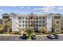 Beautiful condo building with a well maintained exterior and balconies in a professionally landscaped community at 4828 Magnolia Lakes Dr. # 404, Myrtle Beach, SC 29577