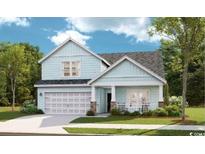 Charming two-story home featuring a front porch, a two-car garage, and classic coastal curb appeal at 541 Magnolia Terrace Dr, Myrtle Beach, SC 29579