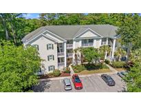 View of a well-maintained condominium with manicured landscaping, ample parking, and private balconies at 601 Hillside Dr. # 4424, North Myrtle Beach, SC 29582