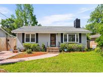 Charming single-story home with a well-manicured lawn, brick walkway, and classic design elements at 719 Juniper Dr., Myrtle Beach, SC 29575